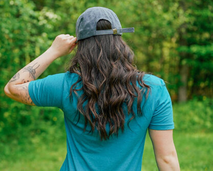person wearing NRCM cap, with back to camera so you can view the hat closure