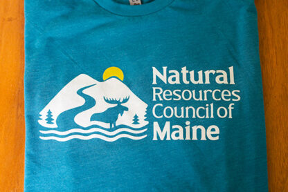 folded up NRCM t-shirt laying on table